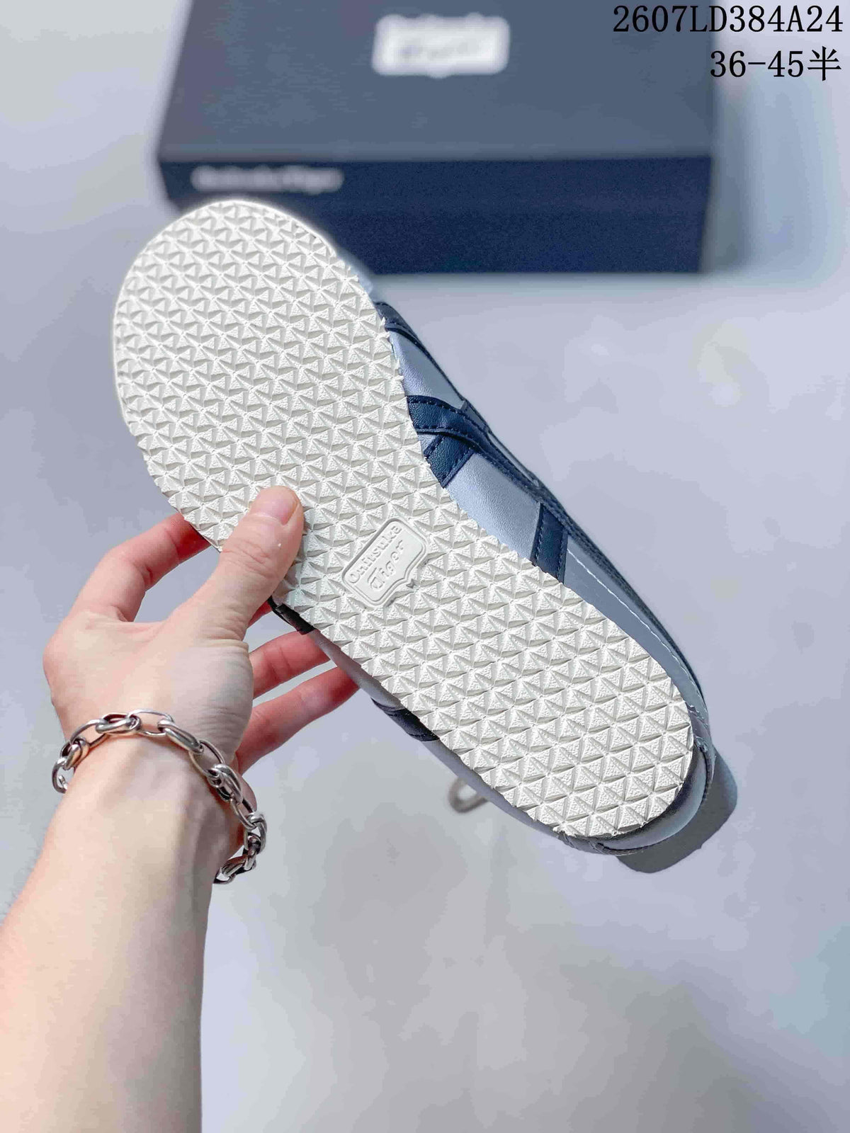 Bottom view showing the white textured outsole and black side detailing of the sneaker.