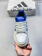 Front view of the adidas Entrap sneaker showing the white perforated toe box, blue tongue and white laces.
