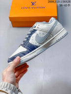 Side view of the low-top sneaker with denim-blue overlays and patterned panels