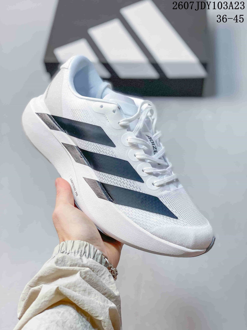 White adidas Adizero low-top sneaker with black side stripes.