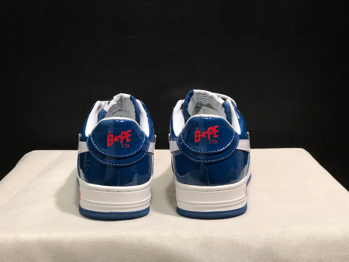 Rear view of the pair showing blue heel panels, white collars, and Bape Sta branding.