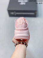 Rear view of the pink low-top shoe showing the heel counter, padded collar, and layered sole.