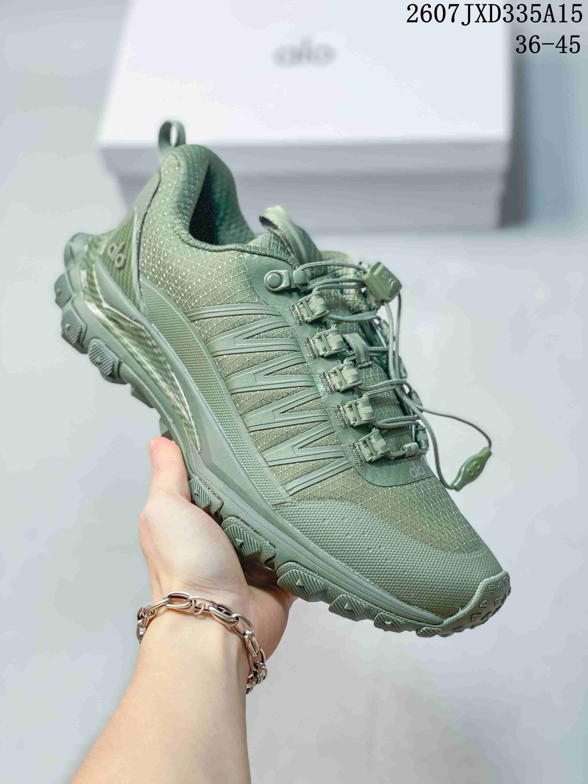 Angled side view of the green Alo sneaker showing the patterned upper, structured side panels, heel branding, and rugged sole.