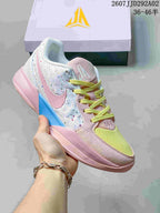 Pink, white and blue Nike JA 2 basketball shoe with yellow laces and a pale pink outsole.