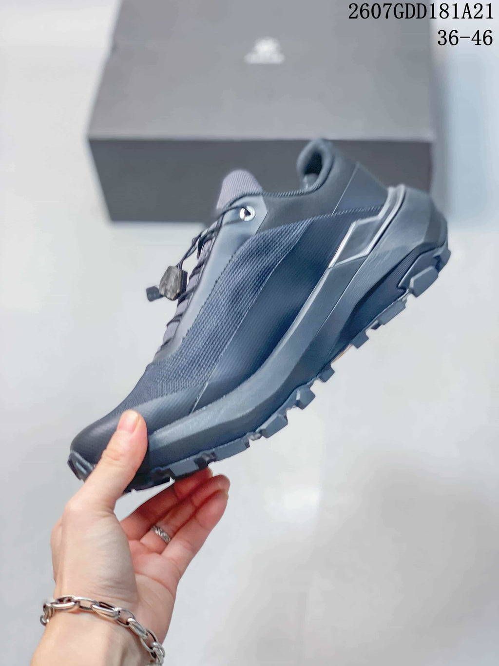 Side view showing the dark gray low-top profile, textured upper and rugged outsole.