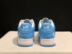 Rear view of the pair showing BAPE STA heel branding, blue heel panels, and white midsoles.