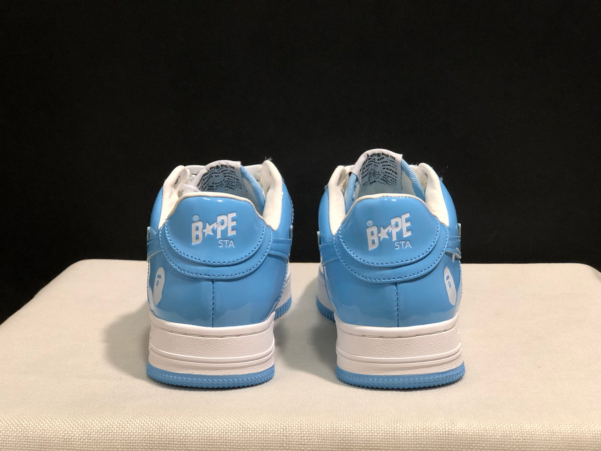 Rear view of the pair showing BAPE STA heel branding, blue heel panels, and white midsoles.