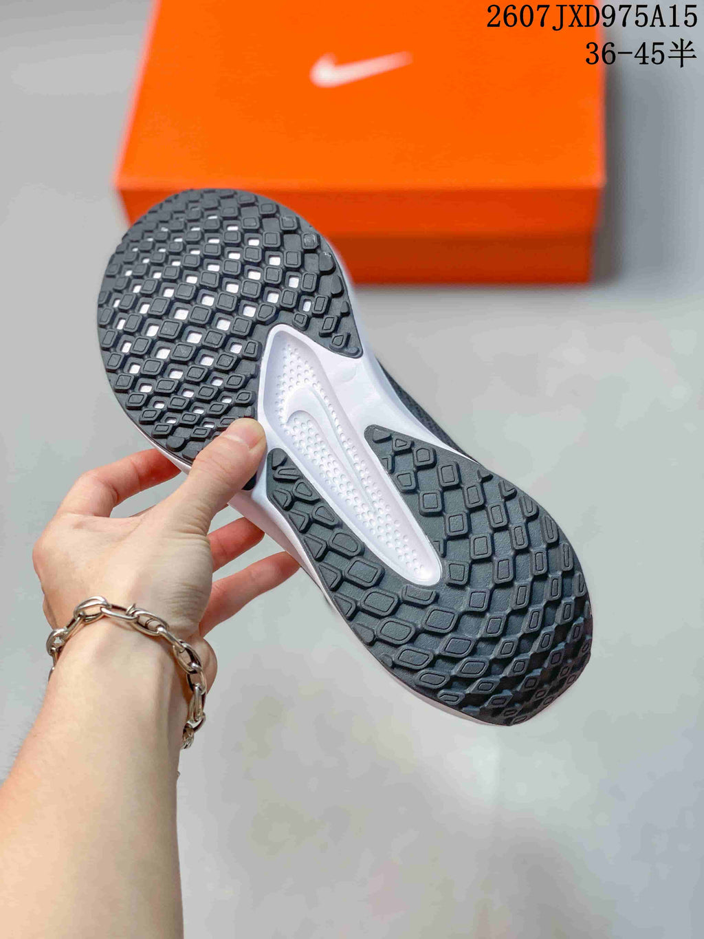 Close-up of the patterned black rubber outsole with rectangular traction blocks.
