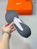 Close-up of the patterned black rubber outsole with rectangular traction blocks.