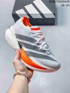 White and gray adidas Adizero Prime X3 shoe with orange sole detailing.