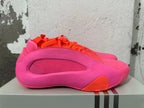 Side view showing the pink upper, sculpted panel and orange accent