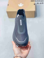 Top view of the black slip-on sneaker showing the slip-on opening, tonal panels and DESCENTE branding.