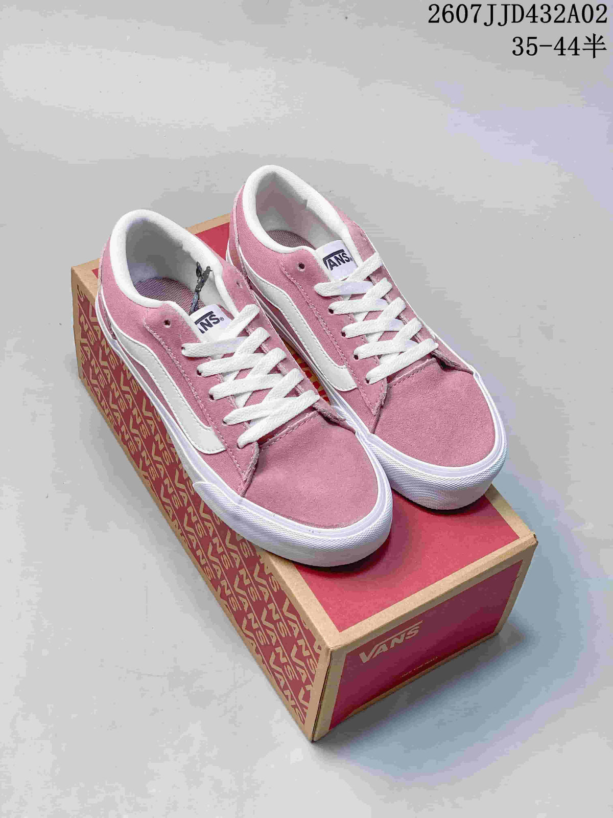 Pair of pink and white Vans Vero LS low-top sneakers on a shoebox