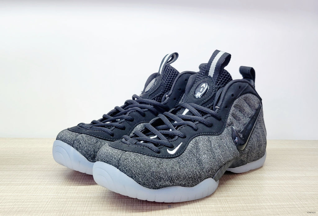 Pair of black and grey Nike Air Foamposite Pro Fleece sneakers shown from the front and side