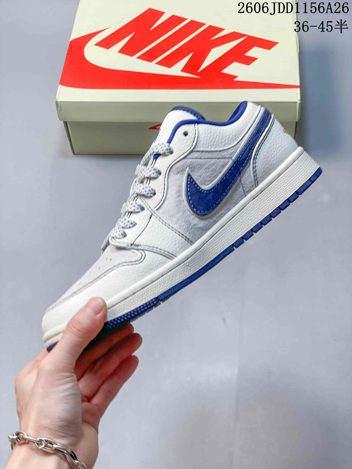 Side profile of the white and blue low-top sneaker showing the contrasting Swoosh, layered panels, white midsole, and blue outsole.