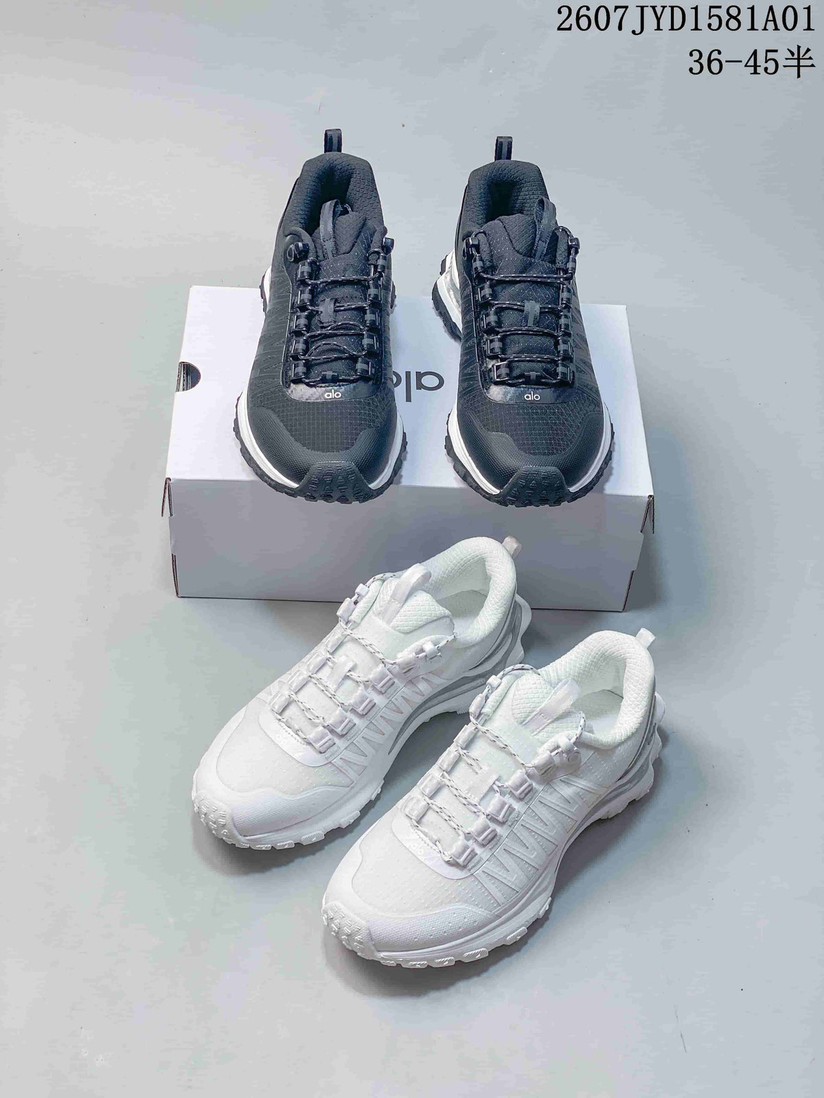 Black and white Alo Trail sneakers shown together.