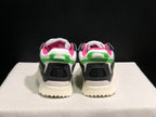 Rear view showing black heel panels, white collars, green rear pull tabs and pink interior lining.