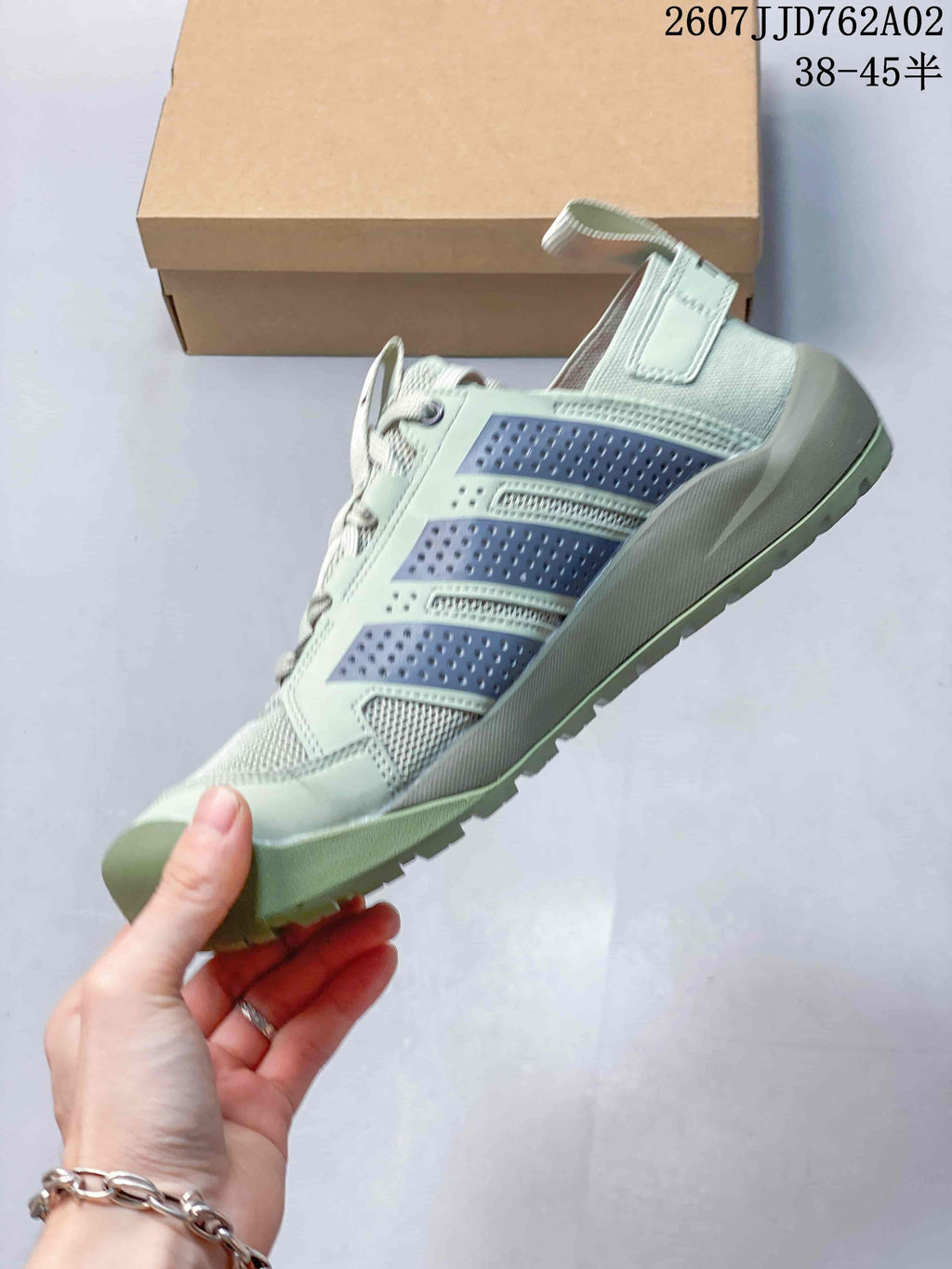 Side view of the shoe with three-stripe detailing and low-cut profile