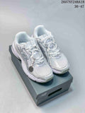 White and silver New Balance 740 sneakers displayed on a shoebox from a front three-quarter angle.
