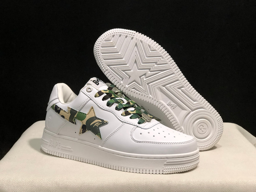 Angled view of the white sneakers with one shoe lifted to reveal the star-patterned white rubber outsole.