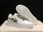 Angled view of the white sneakers with one shoe lifted to reveal the star-patterned white rubber outsole.