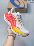 Side view of a white ASICS running sneaker with red, orange, and yellow accents, showing the sculpted midsole and outsole.