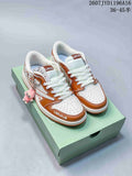 Pair of white and brown low-top Jordan sneakers with Labubu details displayed on a green shoebox.