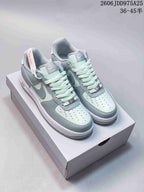 Pair of pale blue and mint low-top sneakers with gray Swoosh details