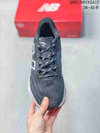Top view showing the dark gray mesh upper, patterned laces and New Balance tongue branding.