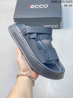 Close-up of a gray adjustable strap sandal showing its open toe, two straps, and molded footbed.