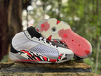 Pair of white Jordan XXXVIII shoes, one showing the translucent outsole with red sections.