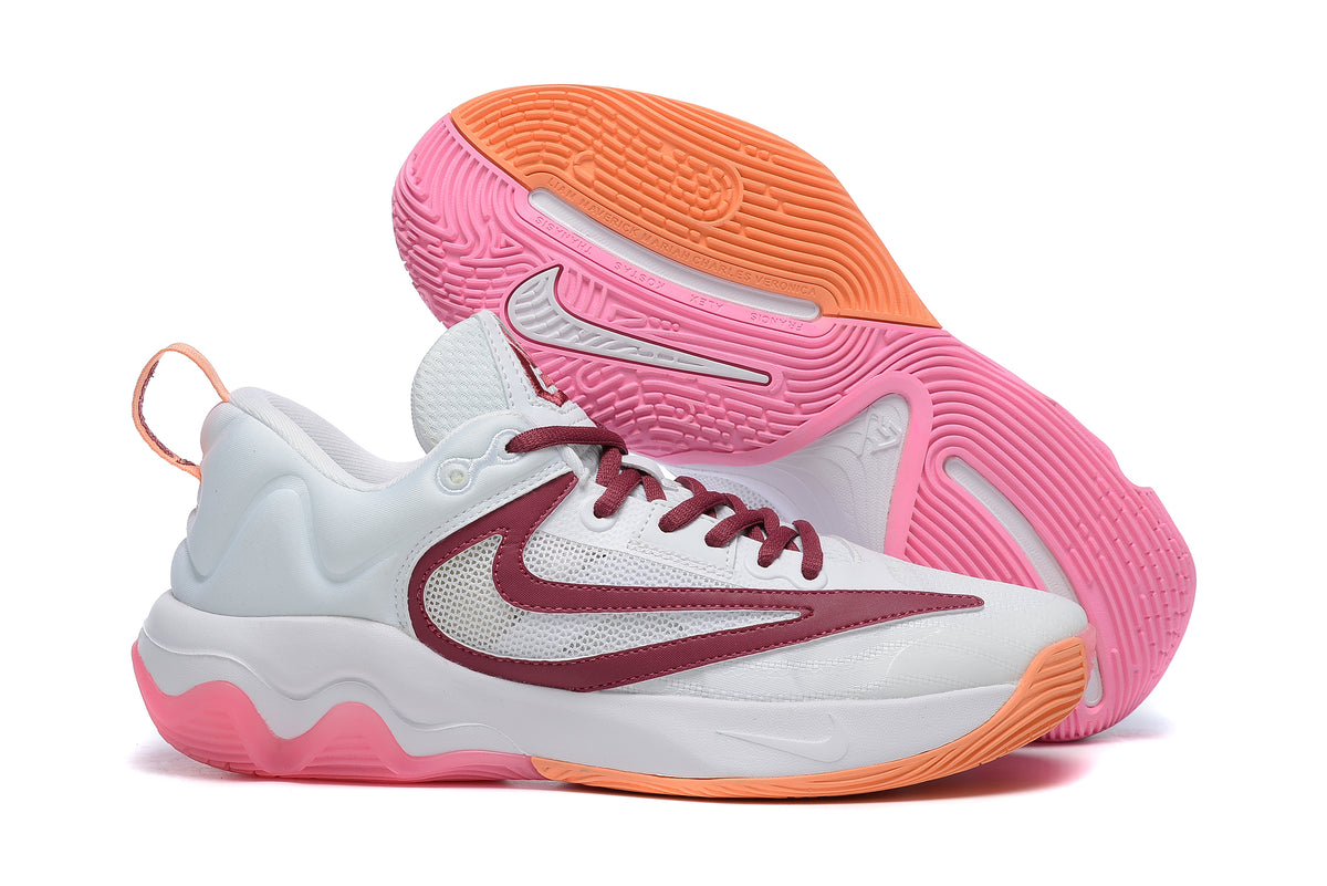White basketball shoe with pink and orange sole accents