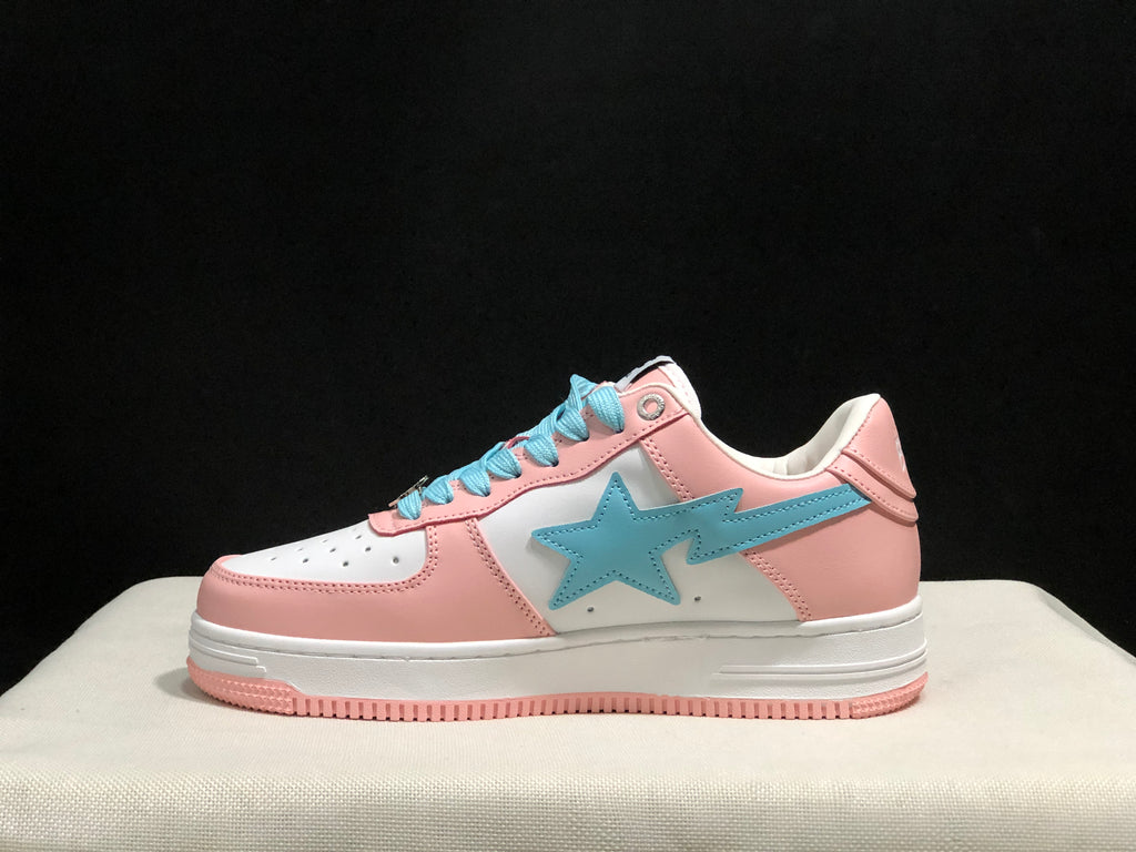 Side profile showing the low-top shape, light-blue star emblem, pink heel, and white midsole.