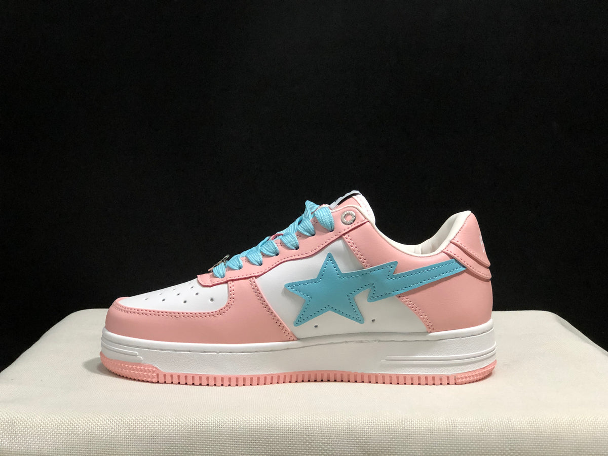 Side profile showing the low-top shape, light-blue star emblem, pink heel, and white midsole.