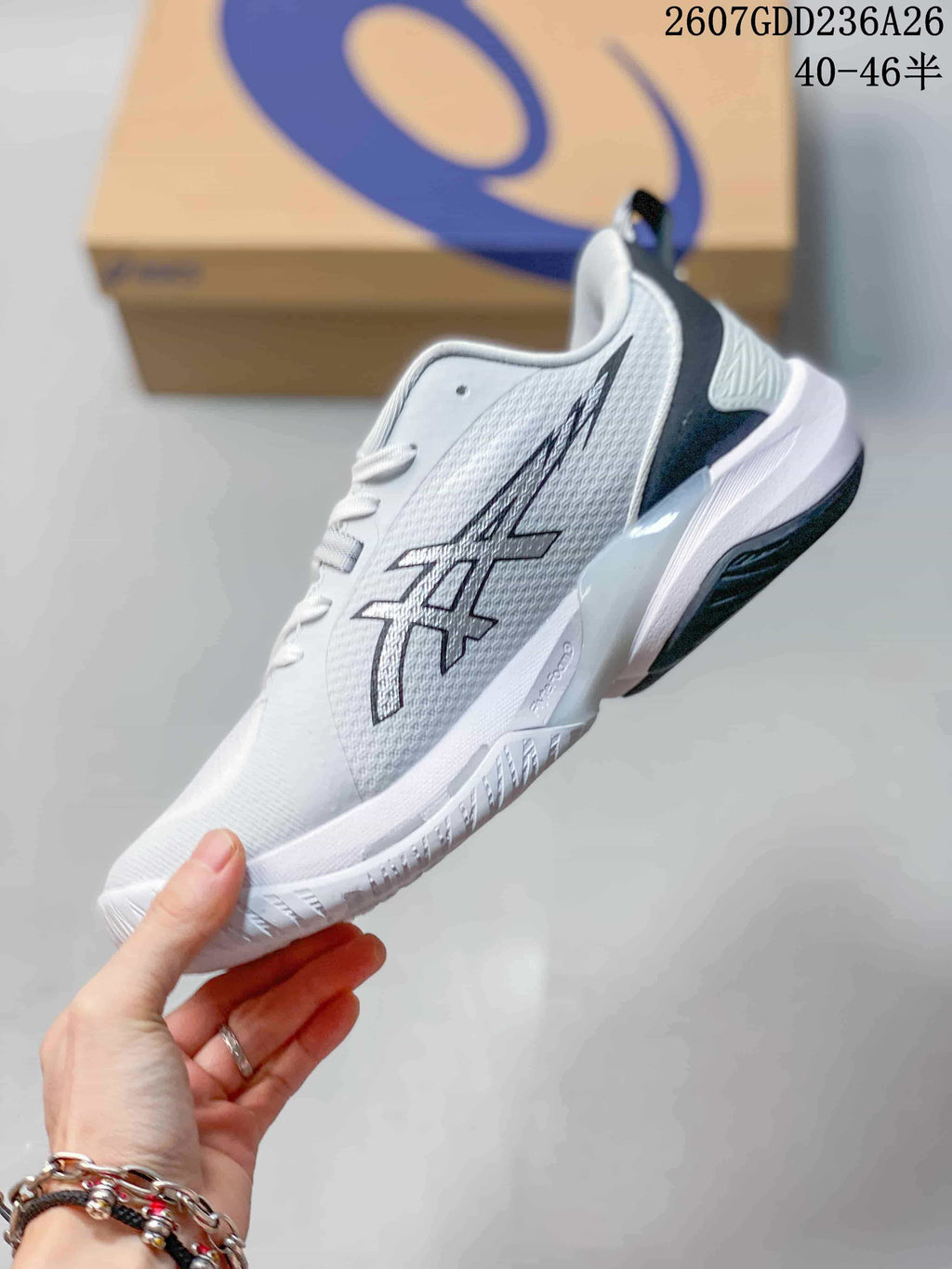 Side view of the white ASICS Swiftace basketball sneaker with black and gray ASICS branding and a raised midsole.