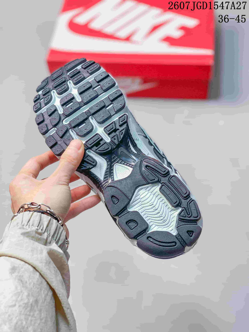 Close-up of the textured black and gray outsole on a Nike Air Max Moto 2K sneaker.