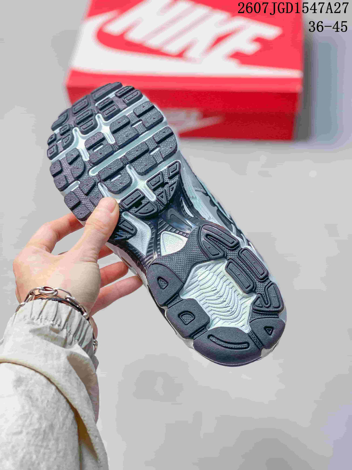 Close-up of the textured black and gray outsole on a Nike Air Max Moto 2K sneaker.