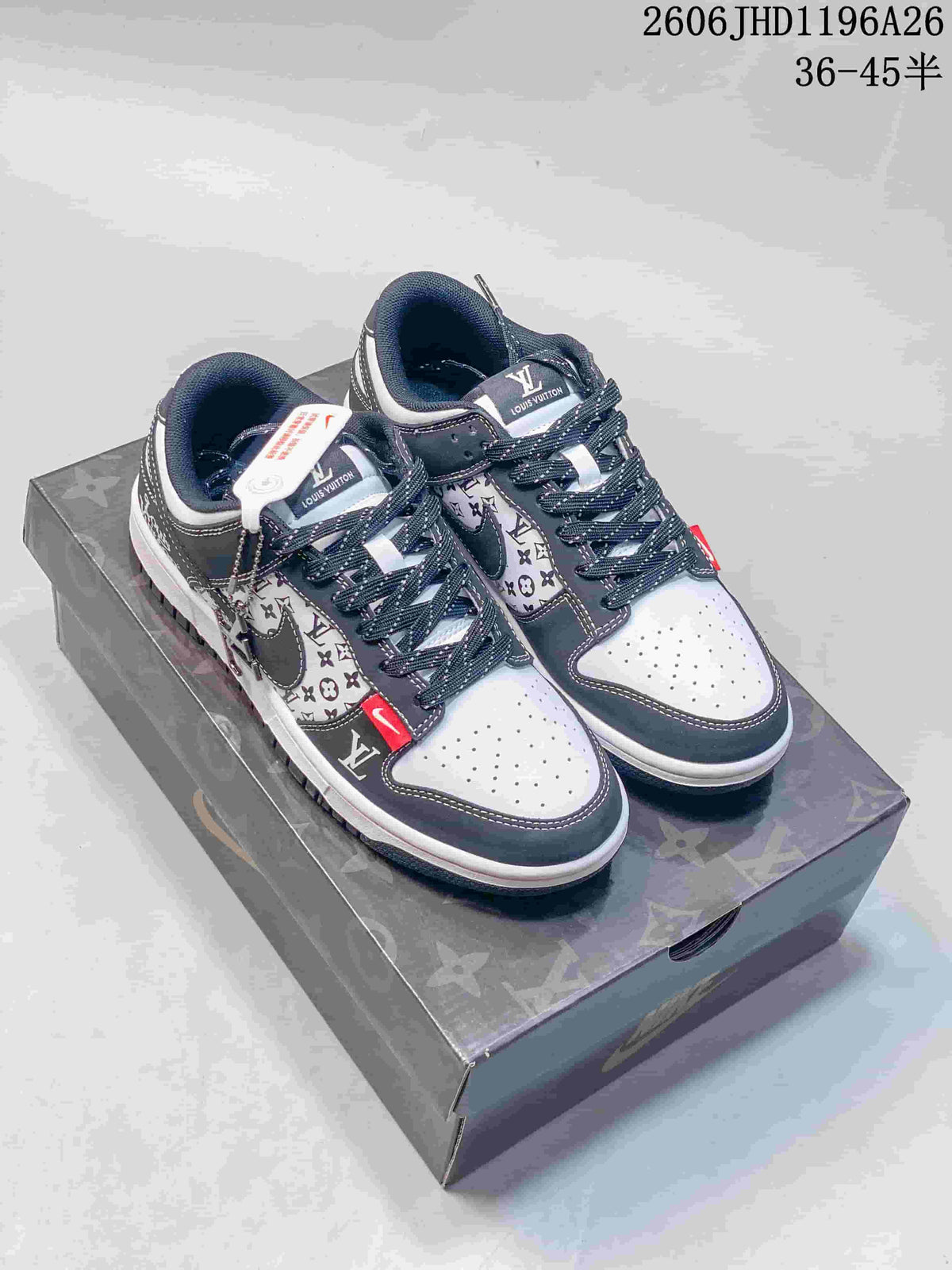 Pair of grey and white patterned Nike SB Dunk Low sneakers on a printed box