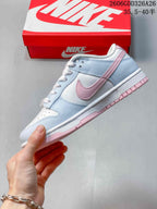 Side view of the low-top sneaker with a pink side logo and pale blue panels