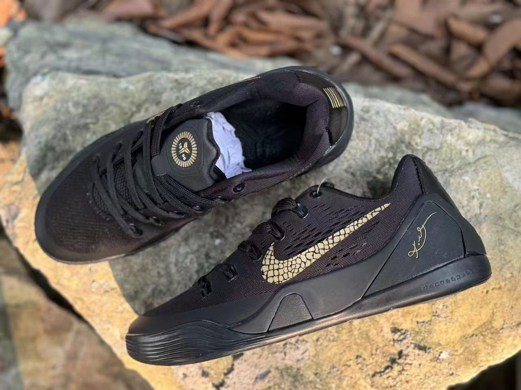 Top and side view of black Kobe 9 shoes with signature heel details.