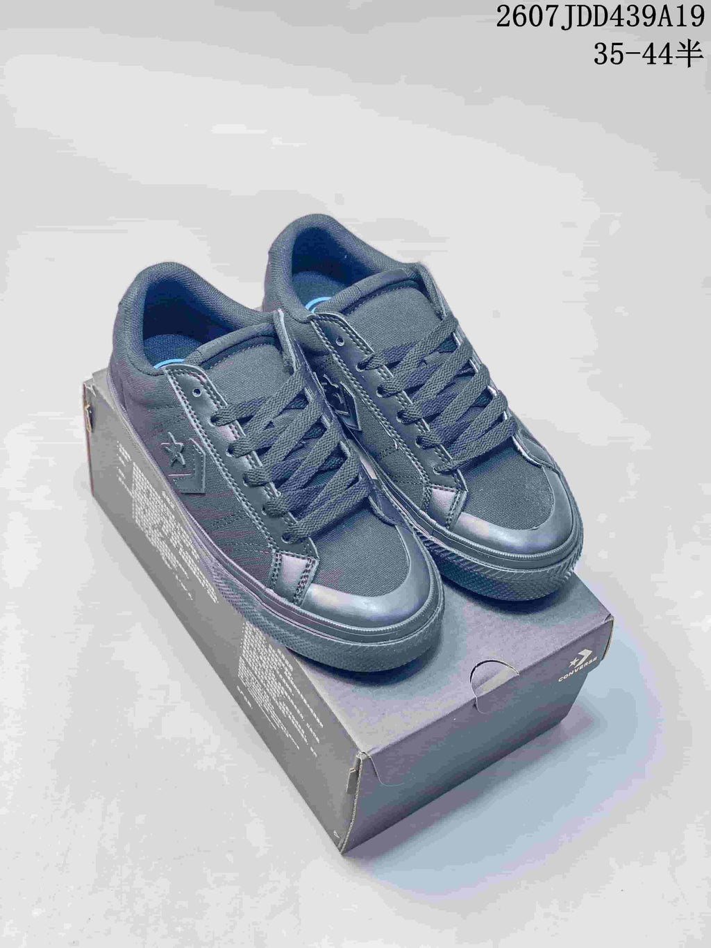 Pair of black Converse All Star low-top sneakers displayed on a Converse shoe box; style code and size range text are visible at the top.