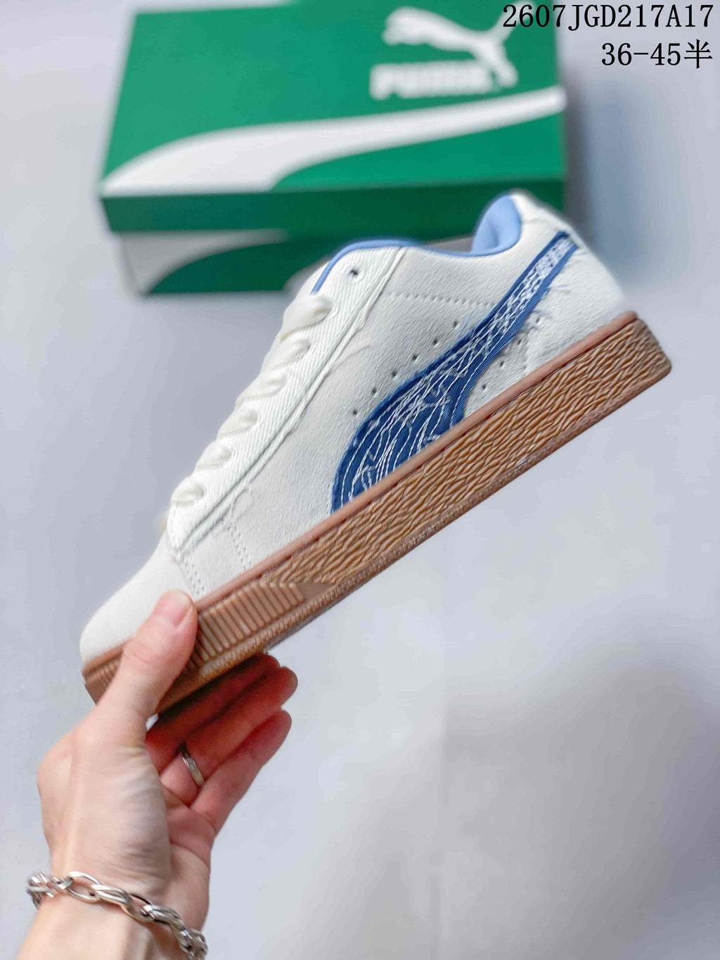 Side profile of the white low-top sneaker with blue side branding, white upper, and gum-colored outsole.