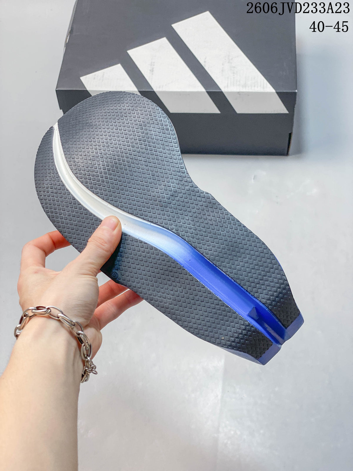 Close view of the shoe outsole with textured tread and a blue midsole section; image overlay shows EU size range 40–45.