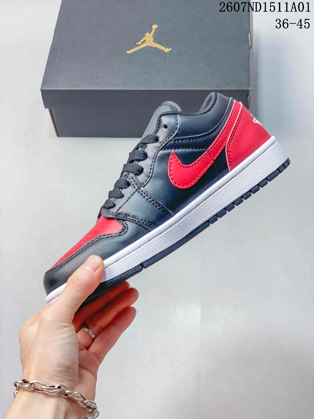Side profile of a black and red low-top Jordan sneaker