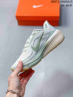 Side view of the light-colored Nike Pegasus 42 sneaker showing the layered side design, green Swoosh, and raised heel.
