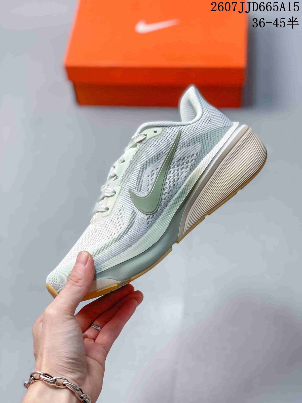 Side view of the light-colored Nike Pegasus 42 sneaker showing the layered side design, green Swoosh, and raised heel.