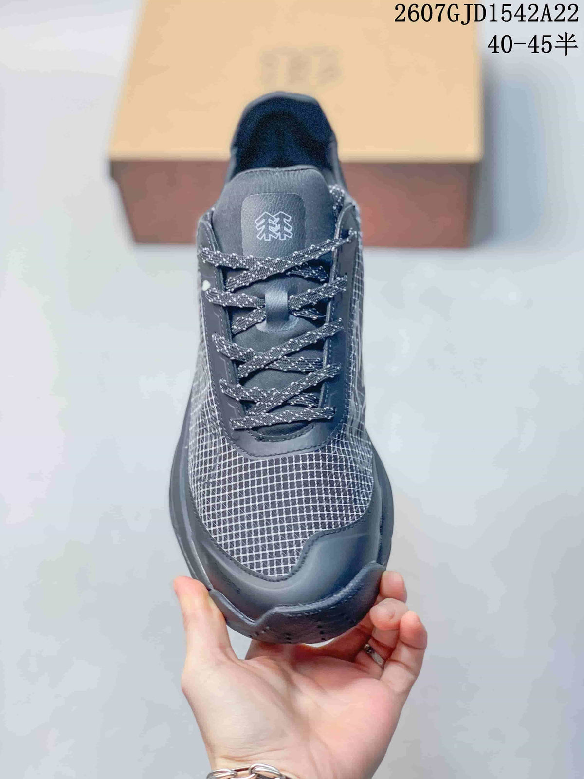 Front view showing the grid-patterned toe, dark protective overlays and patterned laces.