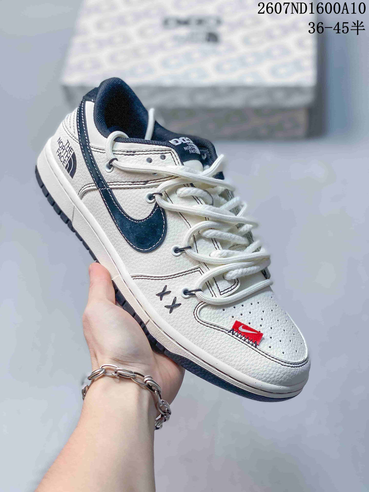 Angled side view showing the white upper, navy Swoosh, red toe detail, heel branding and textured outsole.