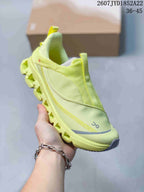 Angled front-side view of the lime yellow On Cloud X 4 sneaker showing the mesh-style upper, gray toe detailing, and segmented sole.