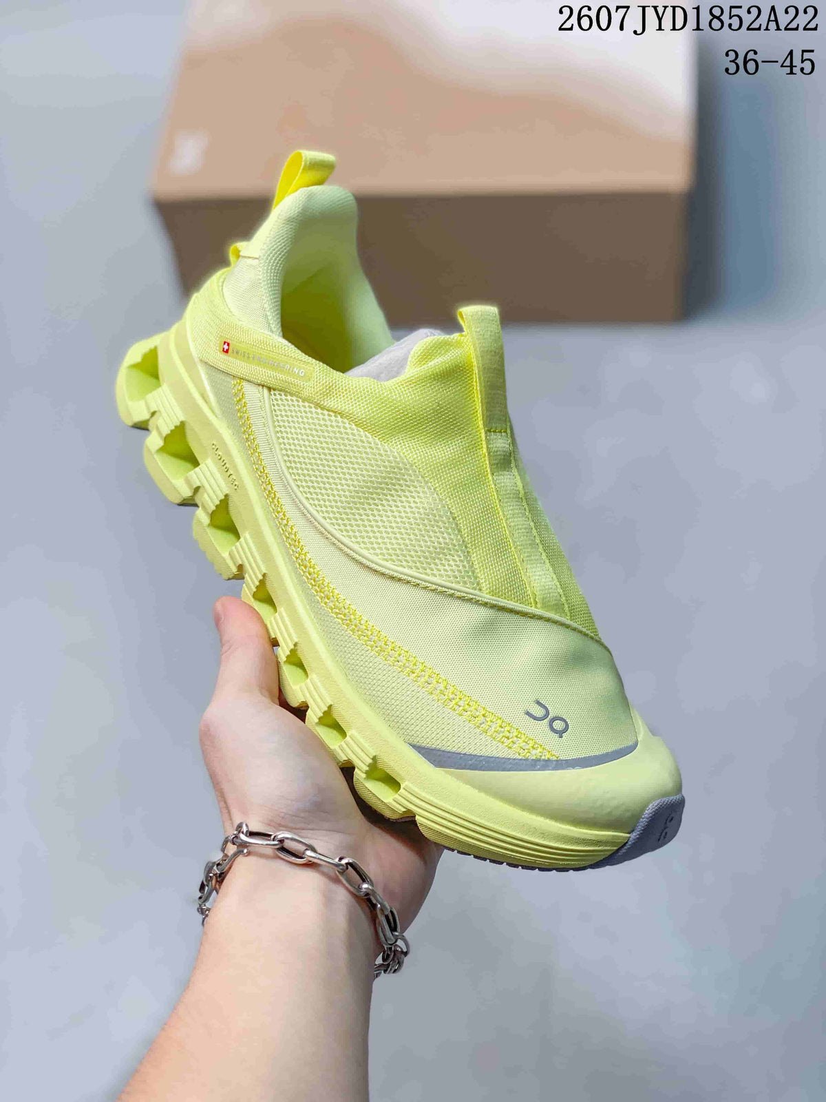 Angled front-side view of the lime yellow On Cloud X 4 sneaker showing the mesh-style upper, gray toe detailing, and segmented sole.